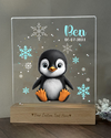 a glass figurine of a penguin with snowflakes