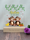 a couple of monkeys sitting on top of a wooden block