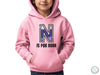 a young boy wearing a pink hoodie with the letter n on it