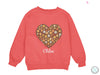 a pink sweater with a heart made out of buttons