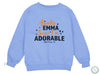 a blue sweatshirt with an orange and black message