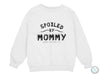 a white sweatshirt that says spoiled by mommy and loving it