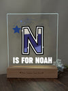 a glass block with the letter n is for noah