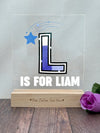 a glass block with the letter l is for llama