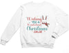 a little girl wearing a white christmas sweatshirt